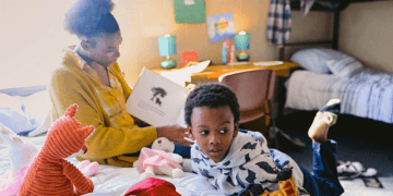 Mom reading to her son.