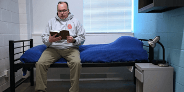 Man reading a book on his bed