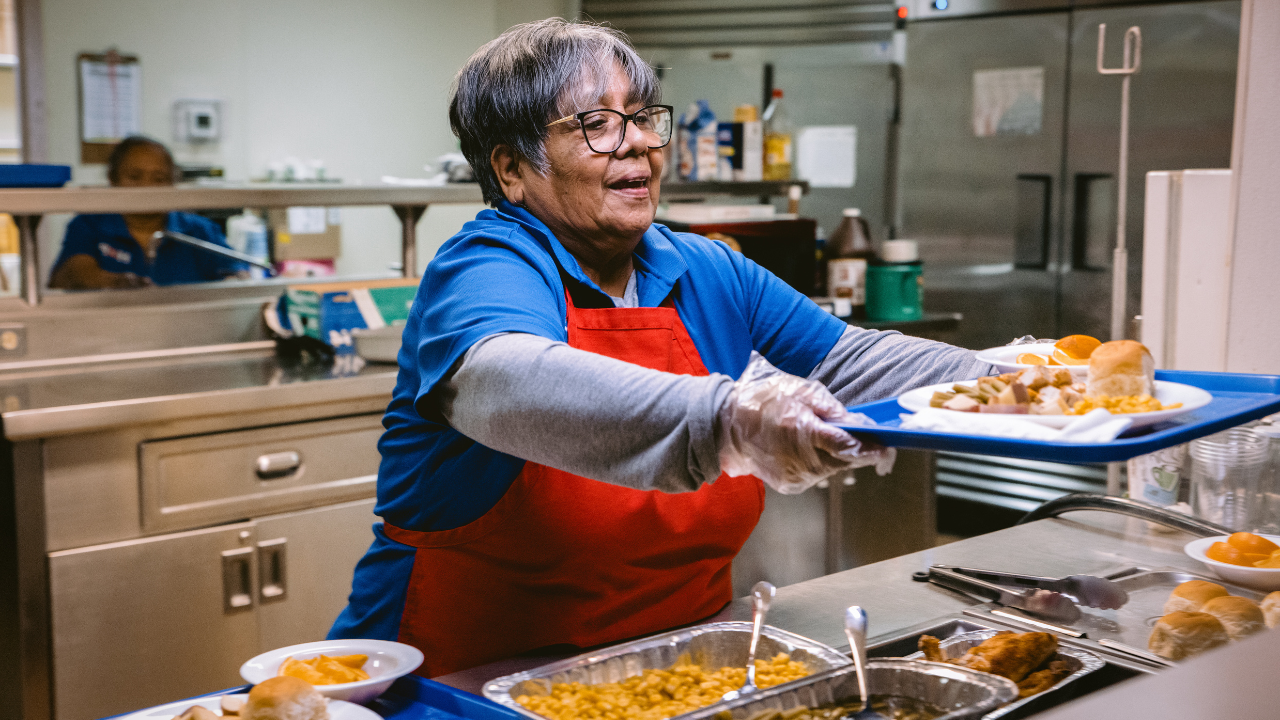 Salvation Army volunteer serving a meal.