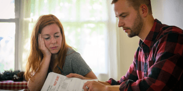 A father examining his overdue bills
