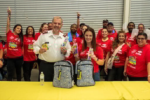 A Salvation Army Officer gathering back to school supplies with volunteers